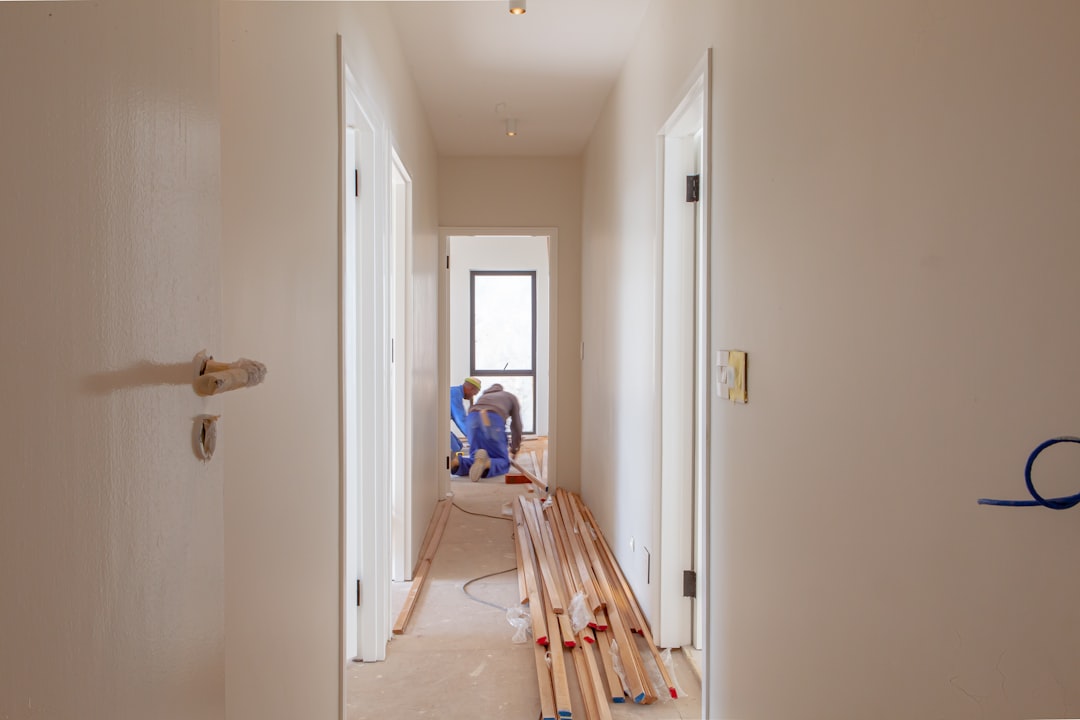 a couple of men working on a house